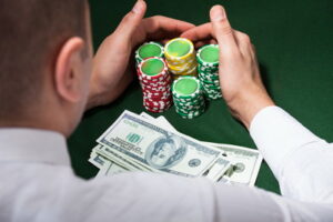 man collects winnings in poker